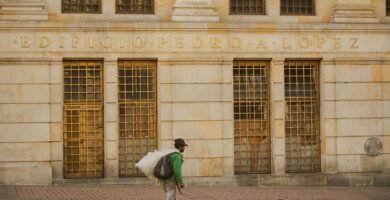 Man walking past Edificio Pedro A. Lopez in downtown Bogota, Colombia