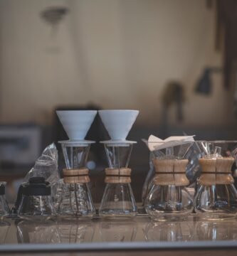 Chemex brewers and coffee accessories arranged on a cafe countertop