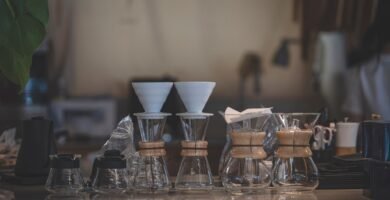 Chemex brewers and coffee accessories arranged on a cafe countertop